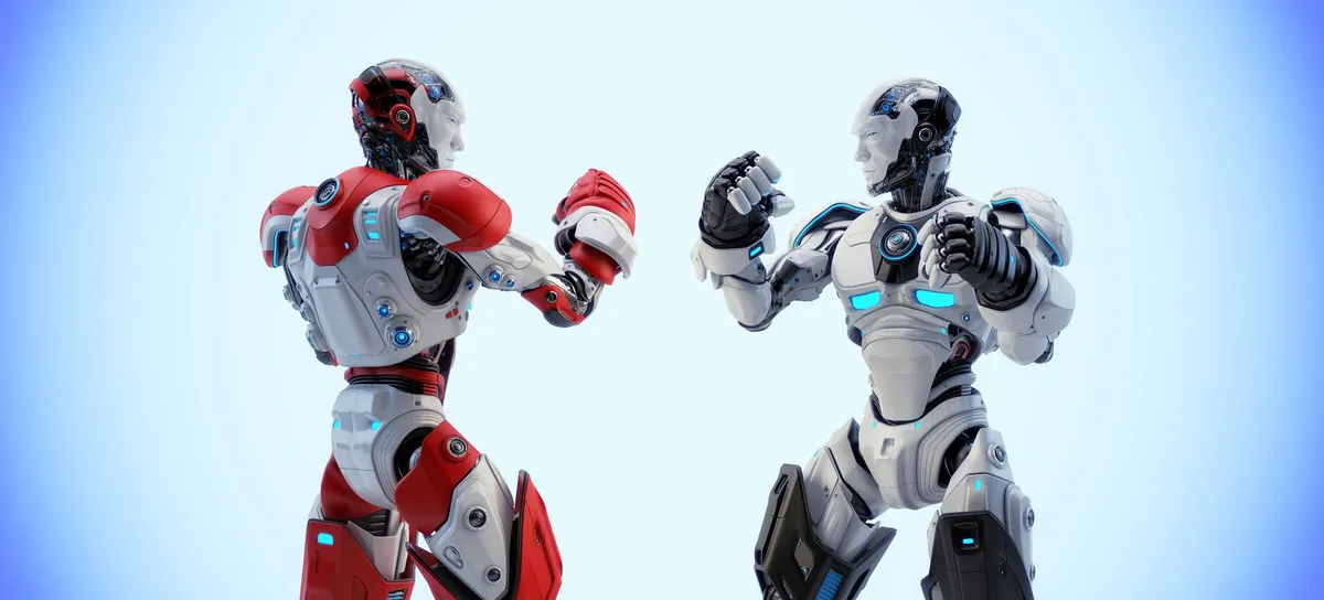 Two identical fighting robots, one red and one white, squaring up to each other with fists raised.